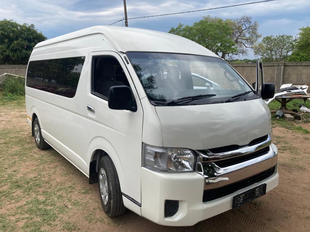 A transport vehicle from a front three-quarter angle, parked in a yard.