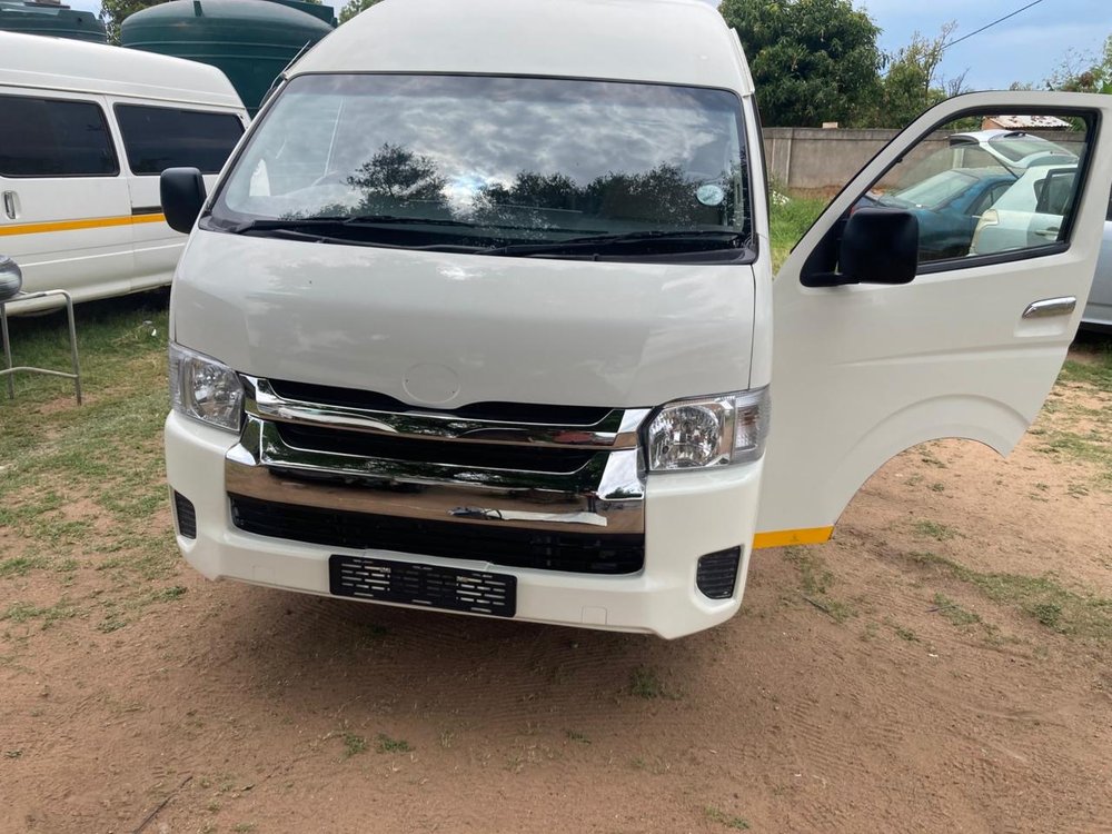 A transport vehicle viewed from the front, parked in a yard.